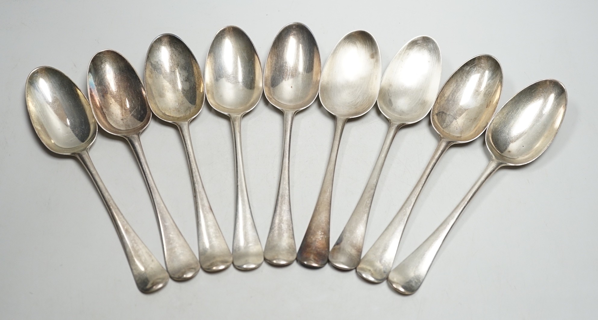 Nine George II silver Hanovarian? pattern tablespoons, eight by Elizabeth Oldfield, London, 1751, 20.7cm, 19.6oz, although some hallmarks are rubbed.